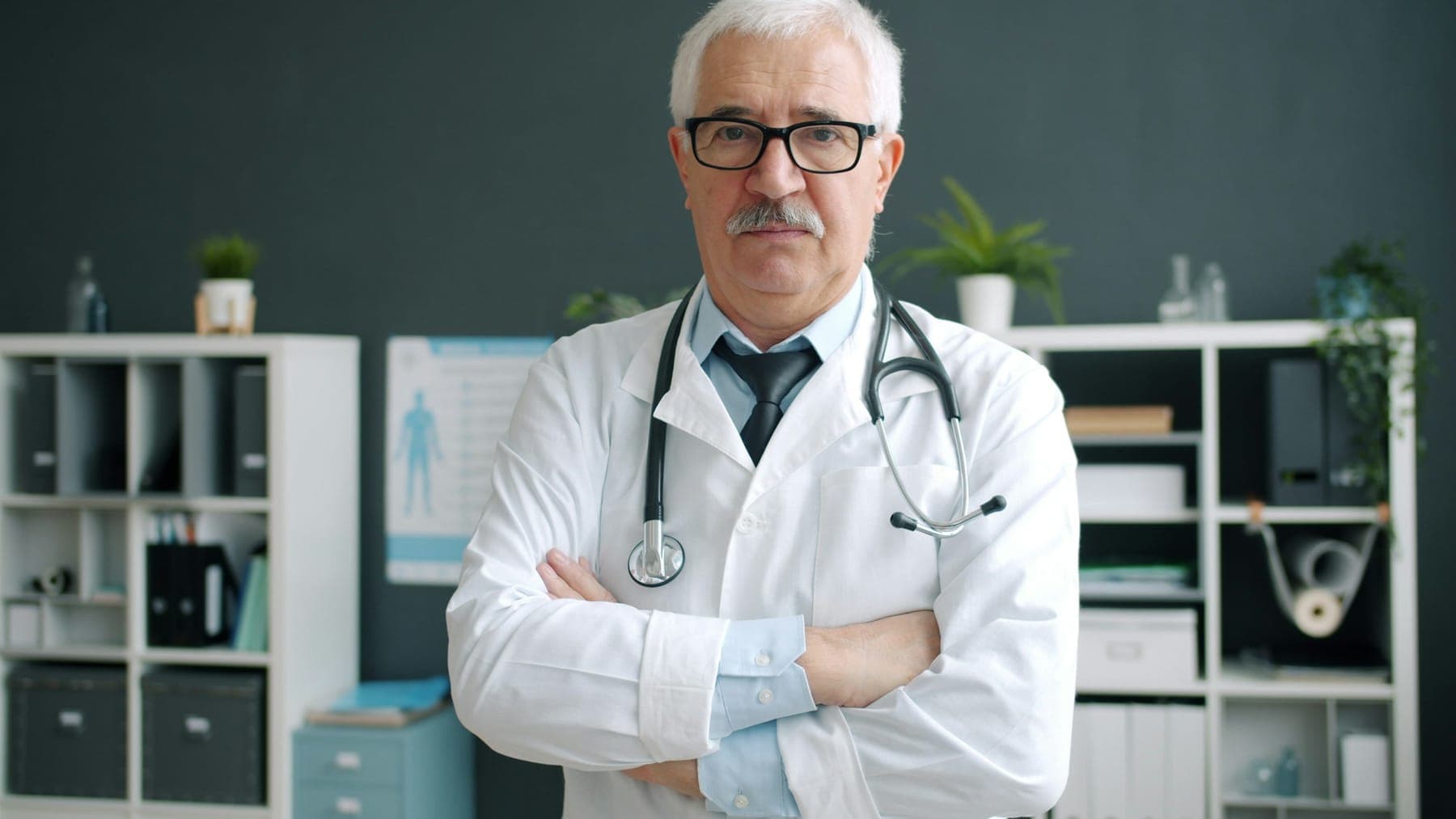 Portrait of Dr. Henrik Lund (sample profile) in a white coat in a clinic