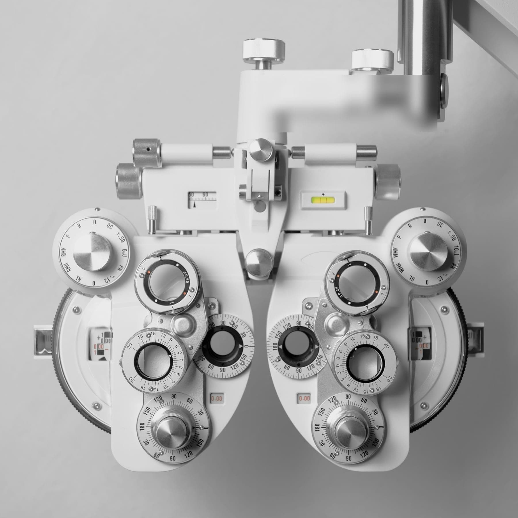 White ophthalmic phoropter instrument on a grey background