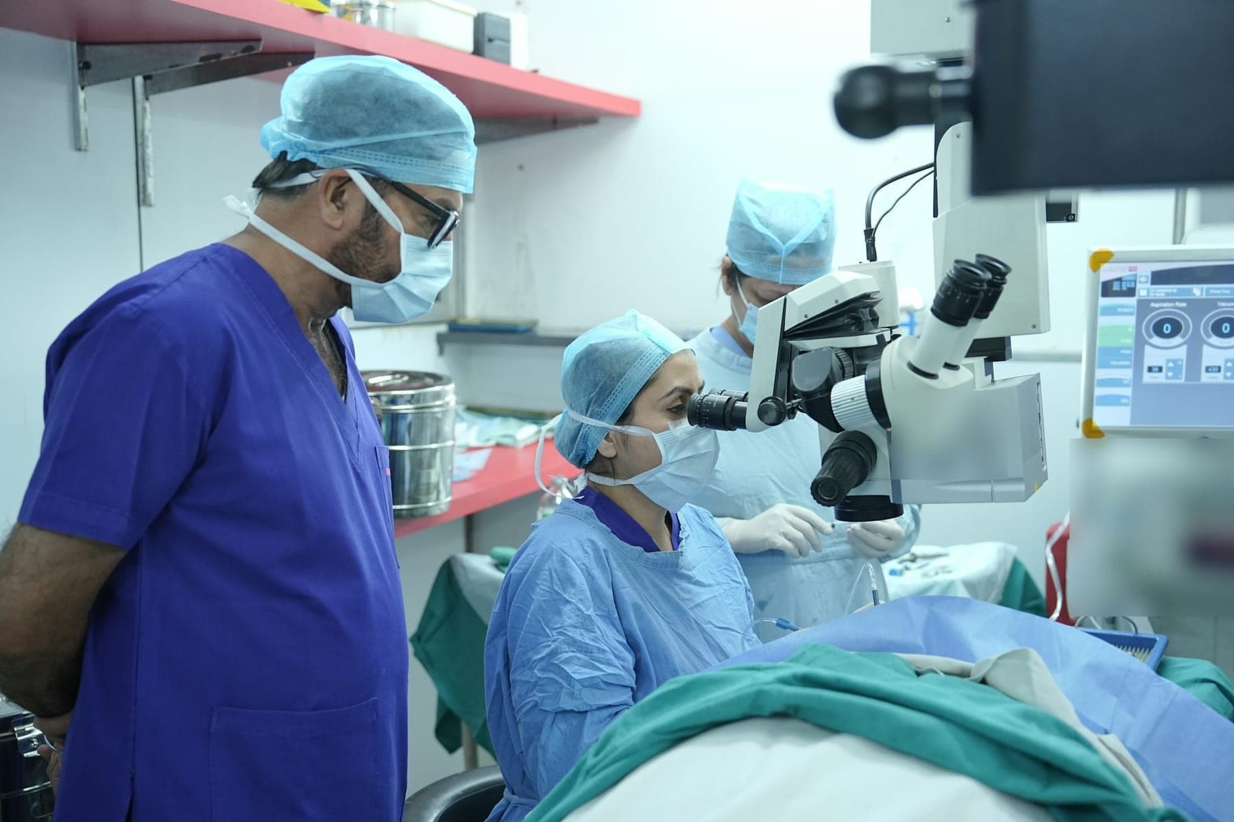 Ophthalmic surgical team working with an operating microscope