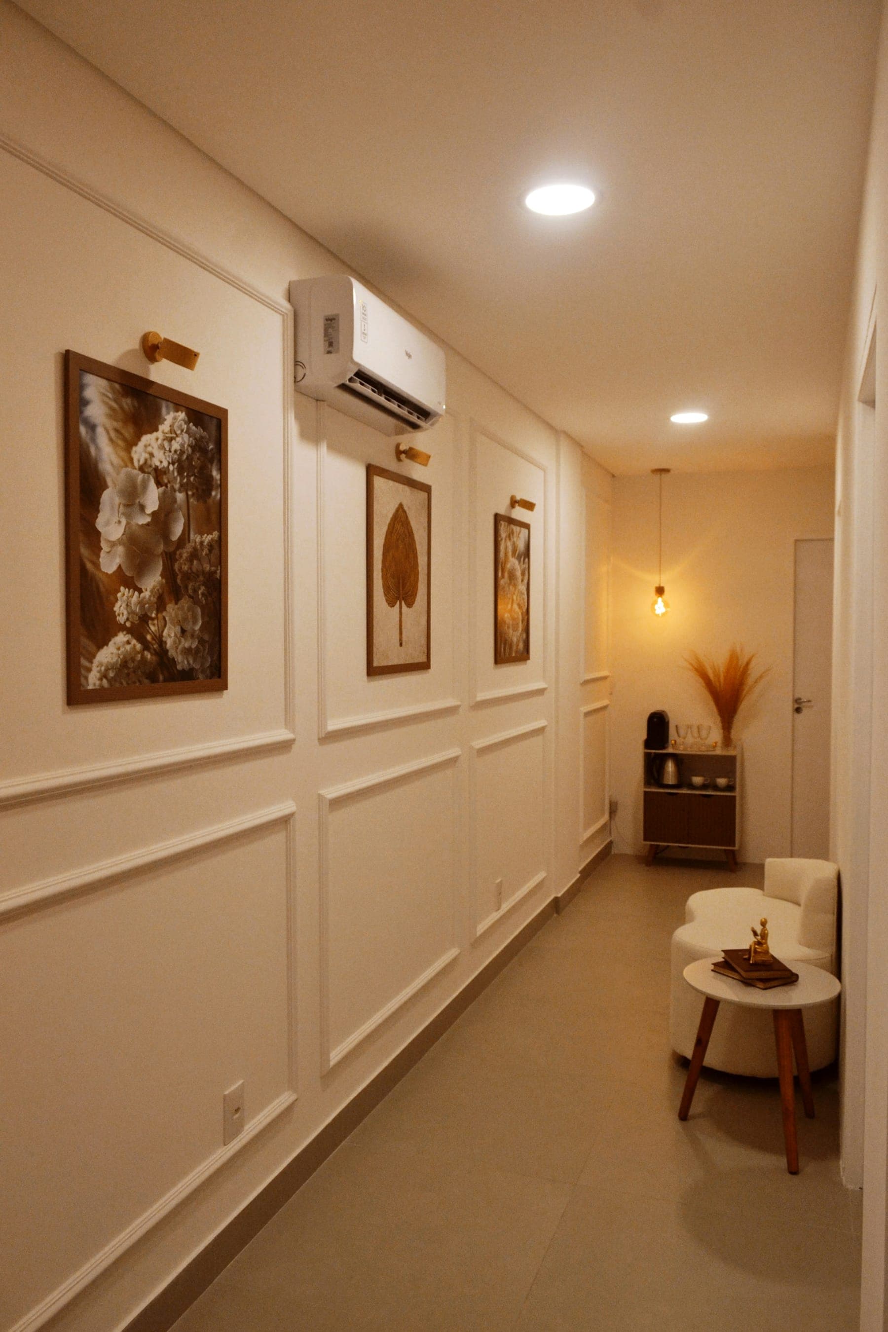 Calm, softly lit clinic corridor with framed artwork