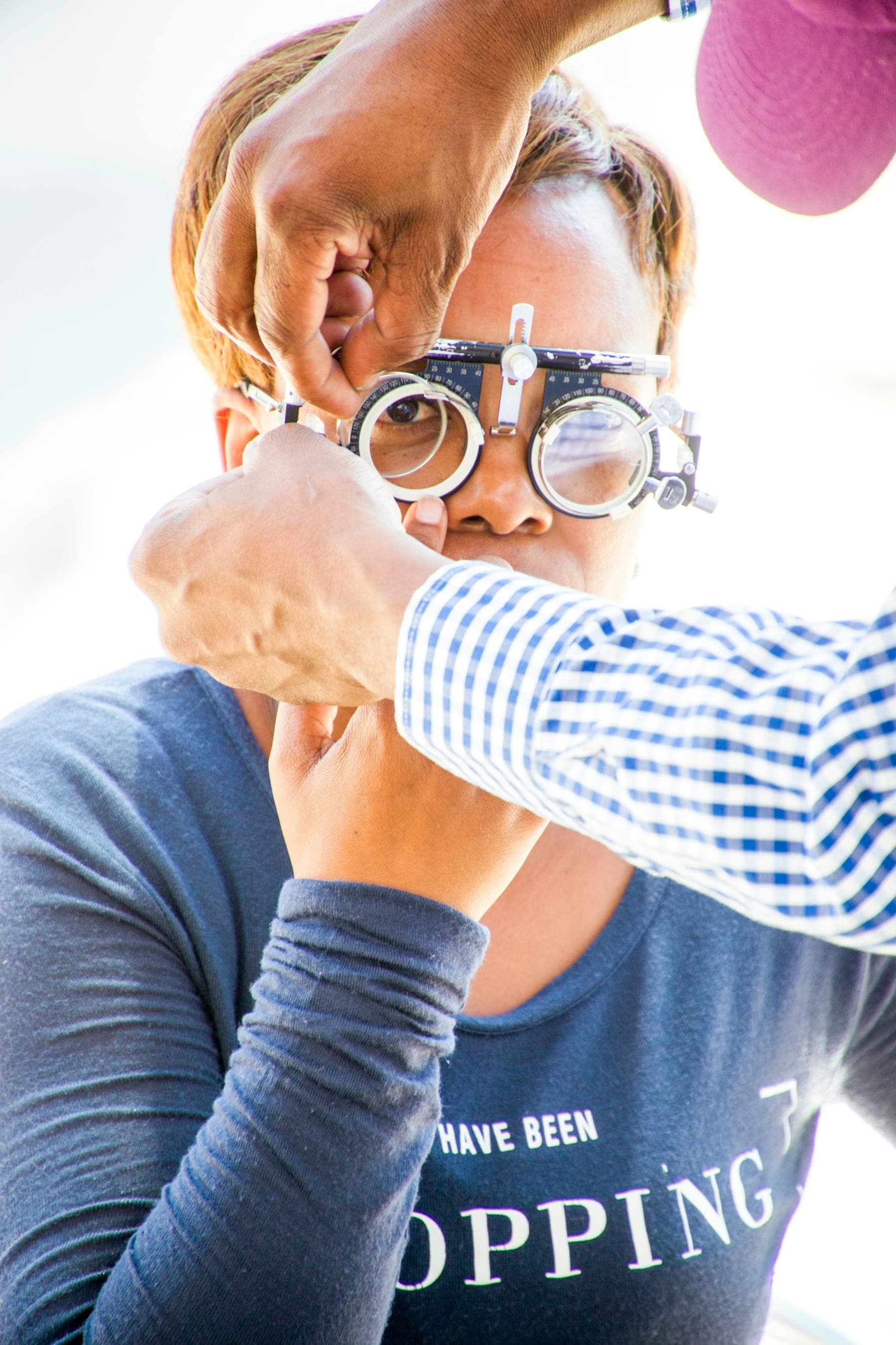 Clinician adjusting a trial frame on a patient's face